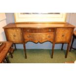 20thC Serpentine topped sideboard with brass drop handles over tapering fluted legs