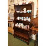 20thC Mahogany waterfall bookcase of 4 shelves with drawer base over bracket feet