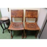 Pair of Brown Leather brass studded cruciform chairs with carved decoration