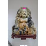 Antique Chinese Buddhist soapstone carved seated Hotei with children surrounding on carved base.