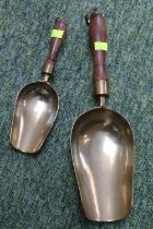 Two antique brass money scoops with turned wooden handles