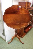 Walnut piecrust tilt top wine table on turned and fluted stem over tripod base