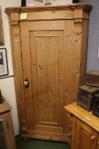 Tall Stripped Pine Scorner Cabinet with fitted shelves and panelled door with applied supports