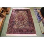 Good quality Red Ground Persian Silk Rug with central medallion and floral borders and tassel end