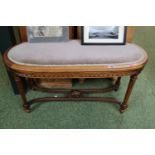 Edwardian Oval upholstered Piano seat with ribbon and fluted legs and and carved cruciform support
