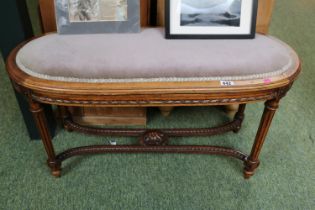 Edwardian Oval upholstered Piano seat with ribbon and fluted legs and and carved cruciform support