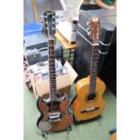 Encore ENC36N Acoustic Guitar and a Gibson marked Electric Guitar
