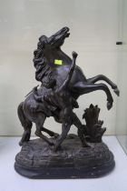 Antique spelter bronze sculpture on wooden base depicting the Marley Horse with trainer originally