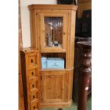 Pine corner unit with glazed top and panelled cupboard base