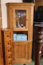 Pine corner unit with glazed top and panelled cupboard base