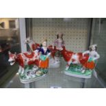Three late 19th century Staffordshire creamers depicting cows & milk maids.