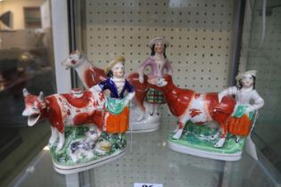 Three late 19th century Staffordshire creamers depicting cows & milk maids.