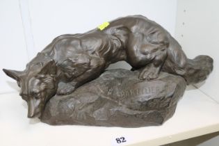 After Bartelier: A bronzed figure of a fox crouching on a rock, signed. 40cm in Height