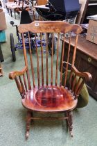 20thC Rocking elbow chair with stick back and scroll arms