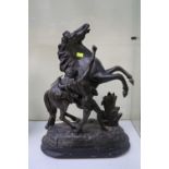 Antique spelter bronze sculpture on wooden base depicting the Marley Horse with trainer originally