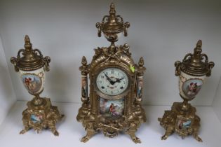 Franz Hermle European Clock and Garnitures with figural decoration and brass foliate decoration,