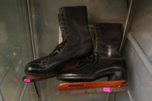 Pair of vintage ladies ice skates and ladies leather boots.