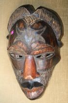 Large hand carved Kenyan Tribal mask with applied metal detail. 38cm in Length