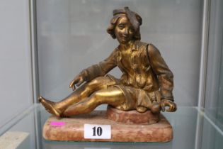 Gilt Bronze figure of a French sitting boy wearing feathered beret surmounted on later wooden base.