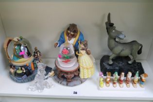 Disney snow globes and various other Disney ornaments to include Beauty and the Beast, Tigger,