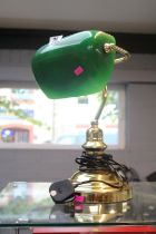 Antique style brass bankers lamp with green glass shade.