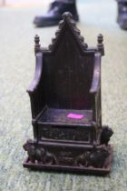 A 1953 Queen Elizabeth II Harper cast iron Coronation money box in the form of a throne