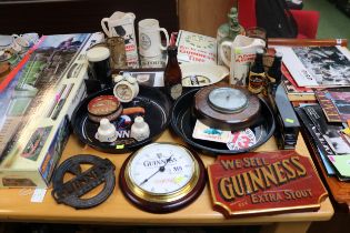 Good collection of Guinness related items inc. Cast Metal Trivet, Advertising clock, Trays etc