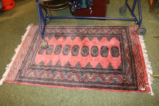 Salmon ground Rug with tassel ends 165cm in Length