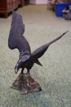 Cold Painted Brass eagle standing on a rocky outcrop. 30cm in Height