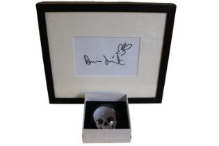 Damien Hirst b.1965 Signature on paper framed and a boxed Paperweight For the Love of God?
