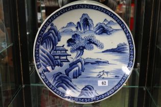 Large Japanese blue and white charger decorated with rocky outcrop and Prunus tree. 37cm in Diameter