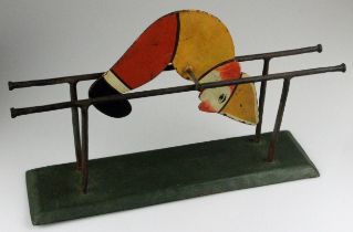 Vintage Kinetic Toy including a Polychrome Rolling Figure and Stand