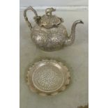 An Indian silver coloured teapot and dish