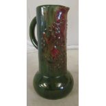 An early 20th Century Eltonware jug green with red flower decoration