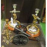 A pair of anchor design candlesticks, another pair of candlesticks and a cannon