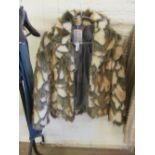 A half length faux fur jacket in soft brown tones and another fake fur jacket