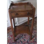 A 19th Century mahogany night table with shaped gallery top and drawer