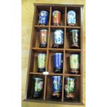 Twelve modern cloisonné beakers with stands on shelf