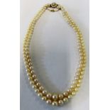 A double strand of cultured pearls with 9ct and pearl cluster clasp