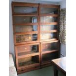 A pair of oak six tier Globe Wernicke bookcases 1 glass missing