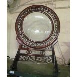 An oriental table screen with central swivel glass centre