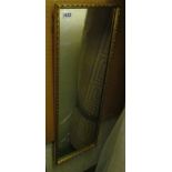 A gilt long wall mirror