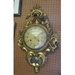 A gilt wood wall clock