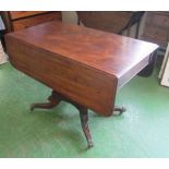 A Regency mahogany Pembroke table on outswept legs and brass paw feet