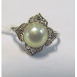 A pearl and illusion set diamond ring