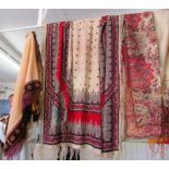 Three antique textiles, two with floral prints, one with embroidered edges and all with tassel