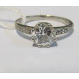 A platinum solitaire diamond ring with diamond shoulders approx 1 carat