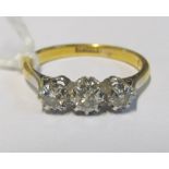 A 9ct and platinum set three stone diamond ring