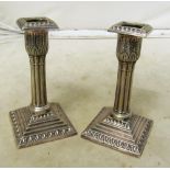 A pair of Walker & Hall white metal fluted column candlesticks