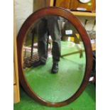 An oval oak mirror